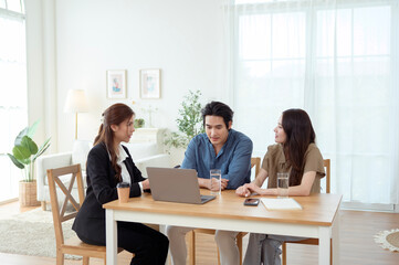 Couple Sharing a Joyful Moment With a Consultant in a Bright Office Space During a Productive Meeting