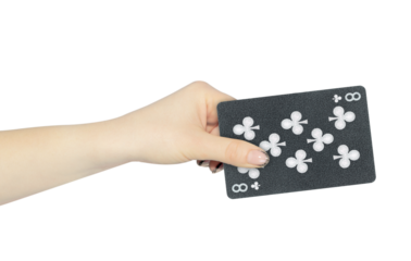 playing card clubs 8 in hand, outstretched hand with black playing card isolated from background