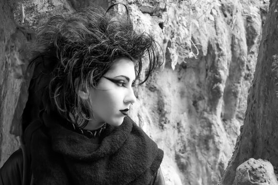 Portrait of Dark gothic fashion youg woman with black makeup, black lipstick and nose piercing. Italian beautiful brunette girl. Dark lady. Dark girl. Trad goth girl. Black and white photo. Close-up 