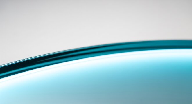 Premium macro of a futuristic medical glass surface with soft cyan reflections, minimalist composition for branding visuals.
