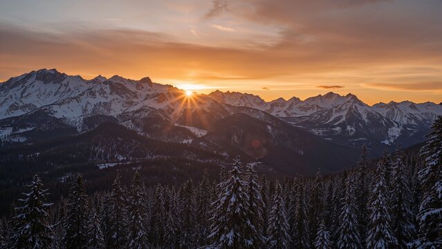 Sunset over snow-capped mountains and pine forest, with the sun just above the peaks, creating a warm glow in the sky. - Powered by Adobe