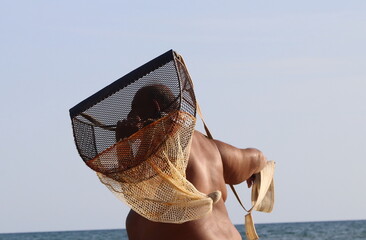 A fisherman using a surfclam scoop/net
