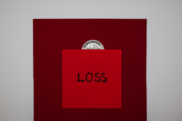 Silver 1oz coin with declining chart and “LOSS” note symbolizing falling silver prices, market downturn, and investment decisions.