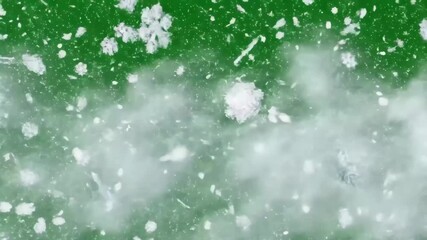 Abstract Snowflakes on Green - A close-up video shows white snowflakes of various shapes and sizes scattered across a vibrant green surface, creating an abstract and wintery scene. - Powered by Adobe