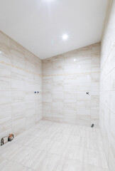 Interior of a Modern White Tiled Bathroom Under Renovation Process. New Costruction Home Interior
