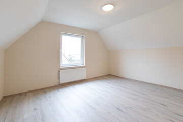 Modern New Construction Empty Room With Wooden Flooring and Large Windows Allowing Natural Light. Home Interior