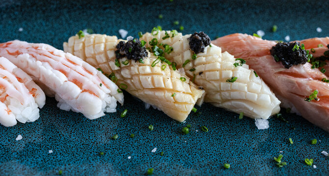 Nigiri sushi platter featuring shrimp, squid, tuna, and caviar - Powered by Adobe
