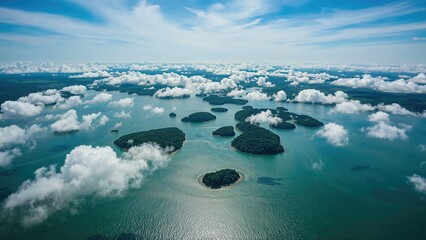 Aerial view of islands and clouds over the sea with a blue sky