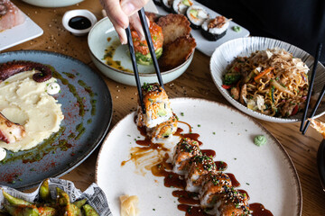 Dining on asian fusion cuisine with sushi and noodles