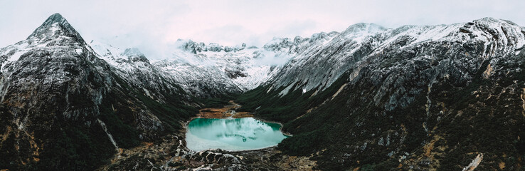 Naklejka premium Laguna Esmeralda surrounded by mountains in Ushuaia, Argentina in Tierra del Fuego by drone