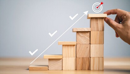 Hand placing final wooden block on ascending staircase with arrow, checkmarks, and target icon on neutral background.