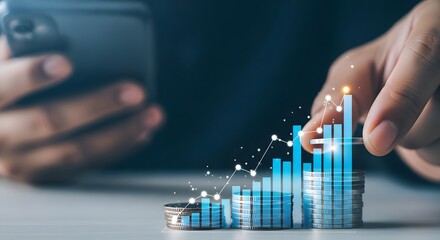 Hand holding smartphone and touching glowing financial growth chart on coins