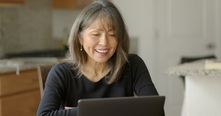 Attractive woman smiling happy talking video call on laptop computer working at home workplace - Powered by Adobe