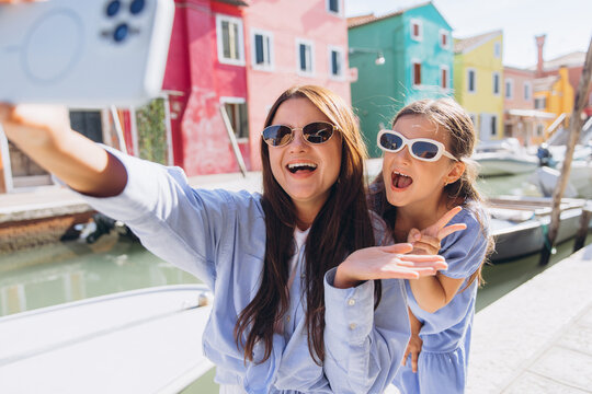 Mother daughter selfie traveling in Burano, Italy