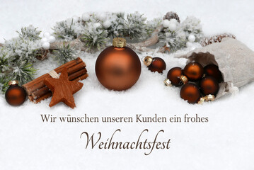 Weihnachtskarte: Braune Weihnachtskugeln und Tannenzweige die im Schnee liegen mit der Beschriftung...