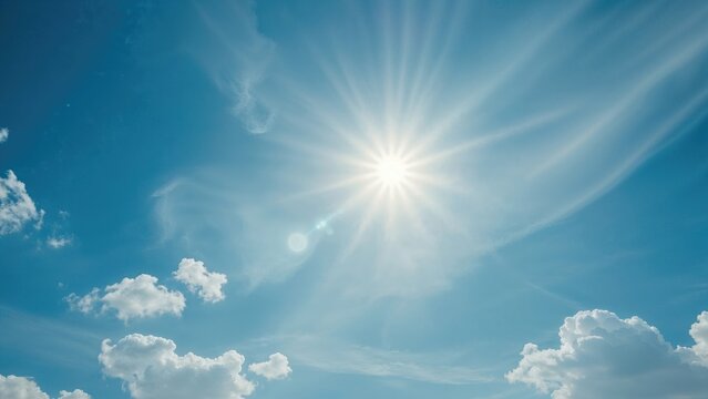 Bright sun in the sky with clouds and rays of sunlight. Clear weather. Nature and weather concepts. The image of sunlight and clouds in the sky.