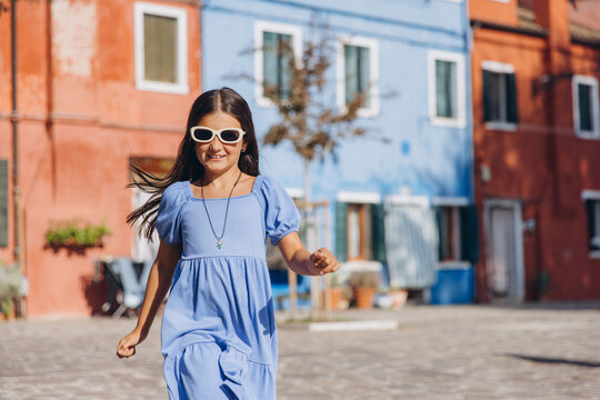 Happy girl traveling Burano island Venice Italy - Powered by Adobe