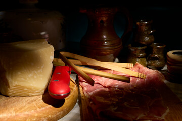 Spanish ham and Parmesan cheese. Board with slices of Serrano ham, typical of Spain, and a piece of Parmesan cheese.