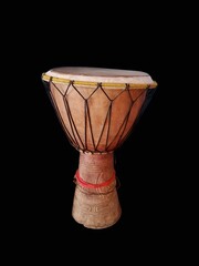 Traditional African djembe drum on black background
