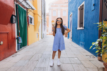 Little girl enjoying ice cream on Burano island