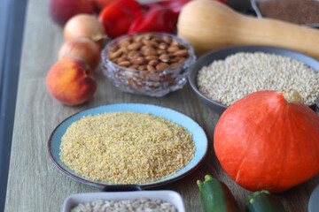 Assortment of various healthy fruits, vegetables, grains and legumes. Selective focus, wooden background.