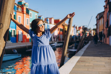 Young girl enjoying travel on Burano island in Venice