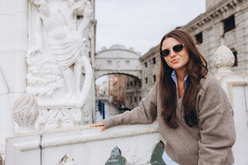Woman traveling in Venice looking at Bridge of Sighs
