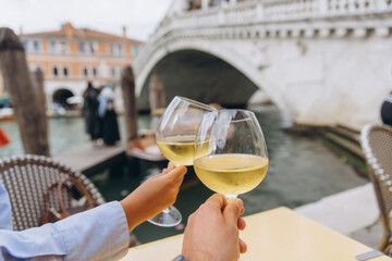 Couple toasting wine enjoying romance in Venice, Italy