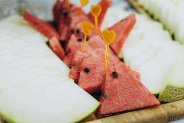 A beautifully arranged display of fresh fruits, artfully cut and styled for a wedding celebration.