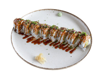 Sushi roll with sauce, sesame, and chives served on plate