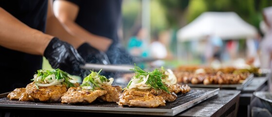 A chef expertly flips steaks on a grill, flames rising, as smoke fills the air at an outdoor cooking event surrounded by friends