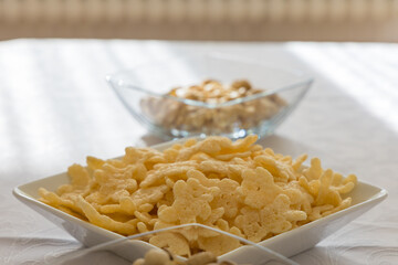 Close-up shot of bowls of crunchy breakfast snacks, captured with a shallow depth of field