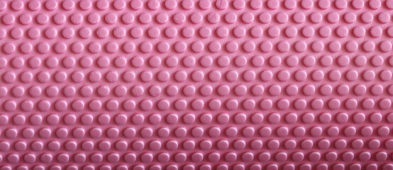 Pink yoga mat surface showing abstract dotted pattern