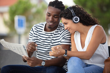 couple standing next to bus and talking