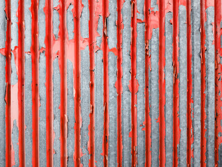 rusty corrugated sheet with peeling red paint