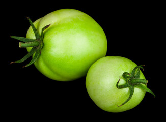 Green tomatoes isolated on black background.