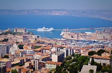 A fascinating top view of Marseille, the Gulf of Lyon, Fort Saint-Jean and the seaport with yachts on a sunny day. In the background - passenger ship Algerie Ferries. Juny 17, 2016. Marseille, France