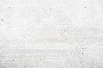 A very light gray concrete surface with minimal imperfections and a clean, bright appearance, a modern and minimalist background