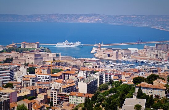 A fascinating top view of Marseille, the Gulf of Lyon, Fort Saint-Jean and the seaport with yachts on a sunny day. In the background - passenger ship Algerie Ferries. Juny 17, 2016. Marseille, France