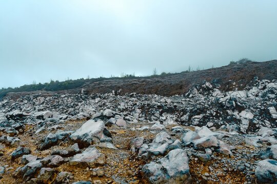 Misty, desolate terrain of fractured volcanic rock and barren soil at Poás Volcano - Powered by Adobe