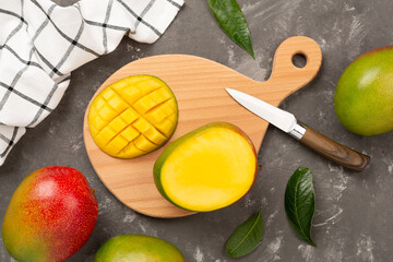 Fresh ripe mango on concrete background, top view