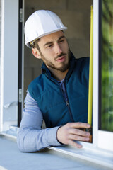Naklejka premium professional worker measuring window height