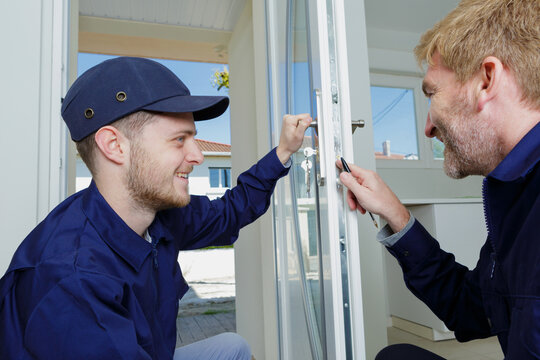 tradesmen checking lock on entrance door to appartment