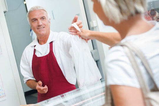 woman and meat from the butcher - Powered by Adobe