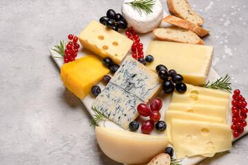 Italian and French gourmet cheese platter with craft cheese assortment on a marble platter. hard cheeses, mold cheese, gorgonzola, pecorino, Emmental, Roquefort cheddar