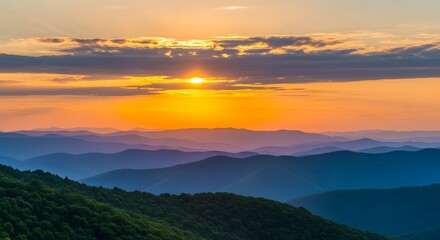 Breathtaking mountain sunrise with vibrant golden light over layered hills and lush forest