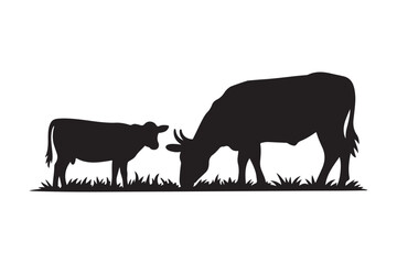 Silhouette of a cow and calf grazing in a field