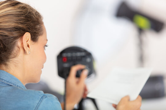 female photographer setting up equipment in the studio