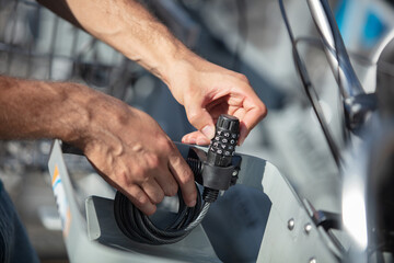 man twisting numbers on a combination lock