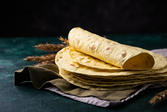 Lavash flat bread on green background